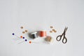 Spool threads, pins, wooden buttons and small scissors Royalty Free Stock Photo