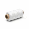 A spool of white thread rests on a white background. The thread is tightly wound aroun Royalty Free Stock Photo