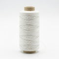 A spool of white thread on a wooden bobbin Royalty Free Stock Photo