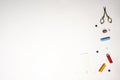 Spools of colored thread, with a threaded needle, gold scissors, and thimble on a white background Royalty Free Stock Photo