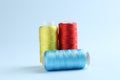 Spools of colorful sewing threads on light background Royalty Free Stock Photo