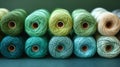 Spools of green and blue thread arranged on a table Royalty Free Stock Photo