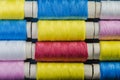 Spools of multi-colored threads arranged in rows Royalty Free Stock Photo