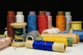 Spools with multi-colored threads on black background, close-up shot Royalty Free Stock Photo