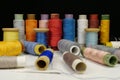 Spools with multi-colored threads on black background, close-up shot Royalty Free Stock Photo