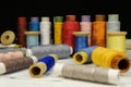 Spools with multi-colored threads on black background, close-up shot Royalty Free Stock Photo