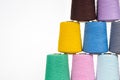 Spools of multicolored cotton thread on a white background lined up in a pyramid with space for text Royalty Free Stock Photo