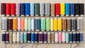 Spools are neatly aligned in four rows, each holding multiple shades of a Royalty Free Stock Photo