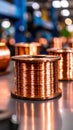 Spools of shiny copper wire on a metallic surface for industrial electric applications manufacturing or engineering work Royalty Free Stock Photo