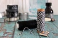 Spools with thread and baker`s twine. Black and white threads