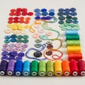 Spools of thread correspond with the button colors, neatly aligned in rows Royalty Free Stock Photo