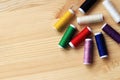 Set of various colorful sewing threads on a wooden table, close-up Royalty Free Stock Photo