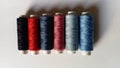 Spools of thread for machine sewing in different colors - red, pink, blue, gray, purple, blueberry, black Royalty Free Stock Photo