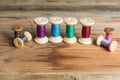 Spools of thread on wooden background. Old sewing accessories.