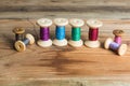 Spools of thread on wooden background. Old sewing accessories. Royalty Free Stock Photo