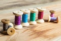 Spools of thread on wooden background. Old sewing accessories. Royalty Free Stock Photo