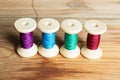 Spools of thread on wooden background. Old sewing accessories. Royalty Free Stock Photo