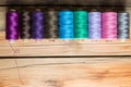 Spools of thread on wooden background. Old sewing accessories. Royalty Free Stock Photo