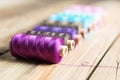 Spools of thread on wooden background. Old sewing accessories. Royalty Free Stock Photo