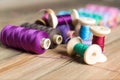 Spools of thread on wooden background. Old sewing accessories. Royalty Free Stock Photo