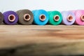 Spools of thread on wooden background. Old sewing accessories. Royalty Free Stock Photo