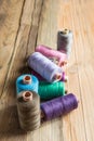 Spools of thread on wooden background. Old sewing accessories. Royalty Free Stock Photo