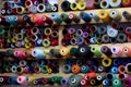 Spools of threads of different colors in tailoring shop