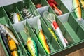 Spoon baits, lures, flies, tackles in box for catching or fishing a predatory fish on deck wood background Royalty Free Stock Photo