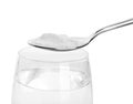 Spoon with baking soda over glass of water Royalty Free Stock Photo