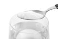 Spoon with baking soda over glass of water Royalty Free Stock Photo