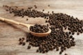 Spoon and black peppercorns Royalty Free Stock Photo