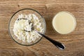 Spoon in bowl with cottage cheese poured condensed milk, condensed milk in bowl on table. Top view Royalty Free Stock Photo