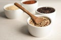 Spoon and bowl with mixed quinoa seeds on table Royalty Free Stock Photo