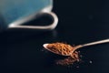 Spoon of cocoa powder and a cup. Royalty Free Stock Photo
