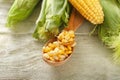 Spoon with corn kernels on wooden table, closeup Royalty Free Stock Photo