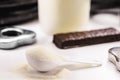 Spoon with Creatine, whey or casein, whey supplements, protein bar for physical exercises, gym in the background, muscle mass gain