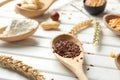 Spoon with flax seeds on white wooden table, closeup Royalty Free Stock Photo