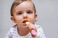 Spoon, food and baby eating in a studio for organic, healthy or nutrition vegetable meal. Sweet, cute and girl kid or Royalty Free Stock Photo