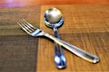 Spoon and fork on a brown mat