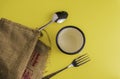 Spoon and fork, DInner concept with yellow back ground, Soft focus in middle