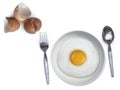 Spoon fork fried egg on plate on a white background Royalty Free Stock Photo