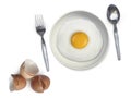 Spoon fork fried egg on plate on a white background Royalty Free Stock Photo