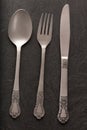 Spoon, fork and knife on black background Royalty Free Stock Photo