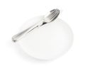 Spoon, fork and knife over the white plate Royalty Free Stock Photo