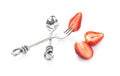 Spoon and fork Stainless steel modern style and strawberry slice on white background Royalty Free Stock Photo