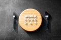 Spoon and fork with World Food Day text on black background