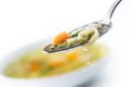 Spoon full of chicken or beef soup with noodles carrot and herbs Royalty Free Stock Photo