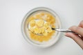 Spoon full of cornflakes in hand Royalty Free Stock Photo