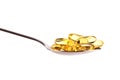 Spoon full of fish oil capsules