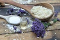 Spoon full of flakes of soap with essential oil and bunch of lavender flowers Royalty Free Stock Photo